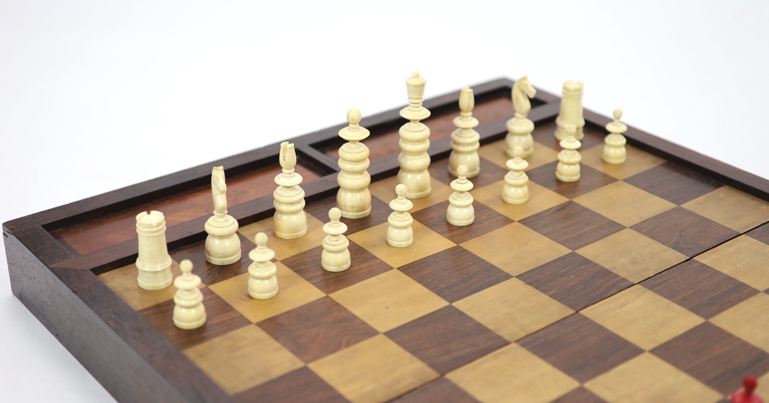 An early 20th century rosewood folding games board, external chess and internal backgammon, W 75cm D 56cm when open, W 75cm D 37cm when closed